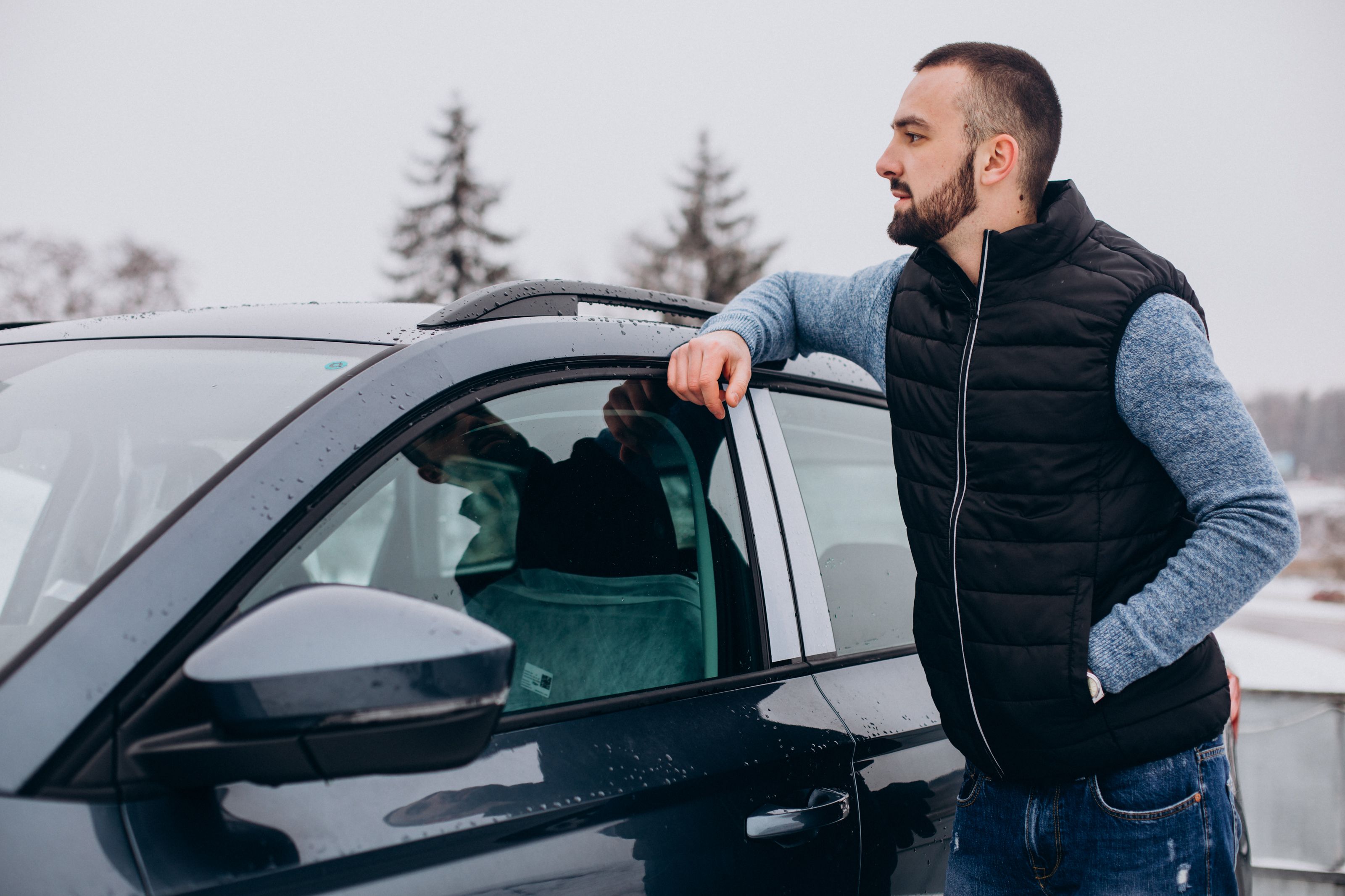 handsome-man-warm-jacket-standing-by-car-covered-with-snow.jpg
